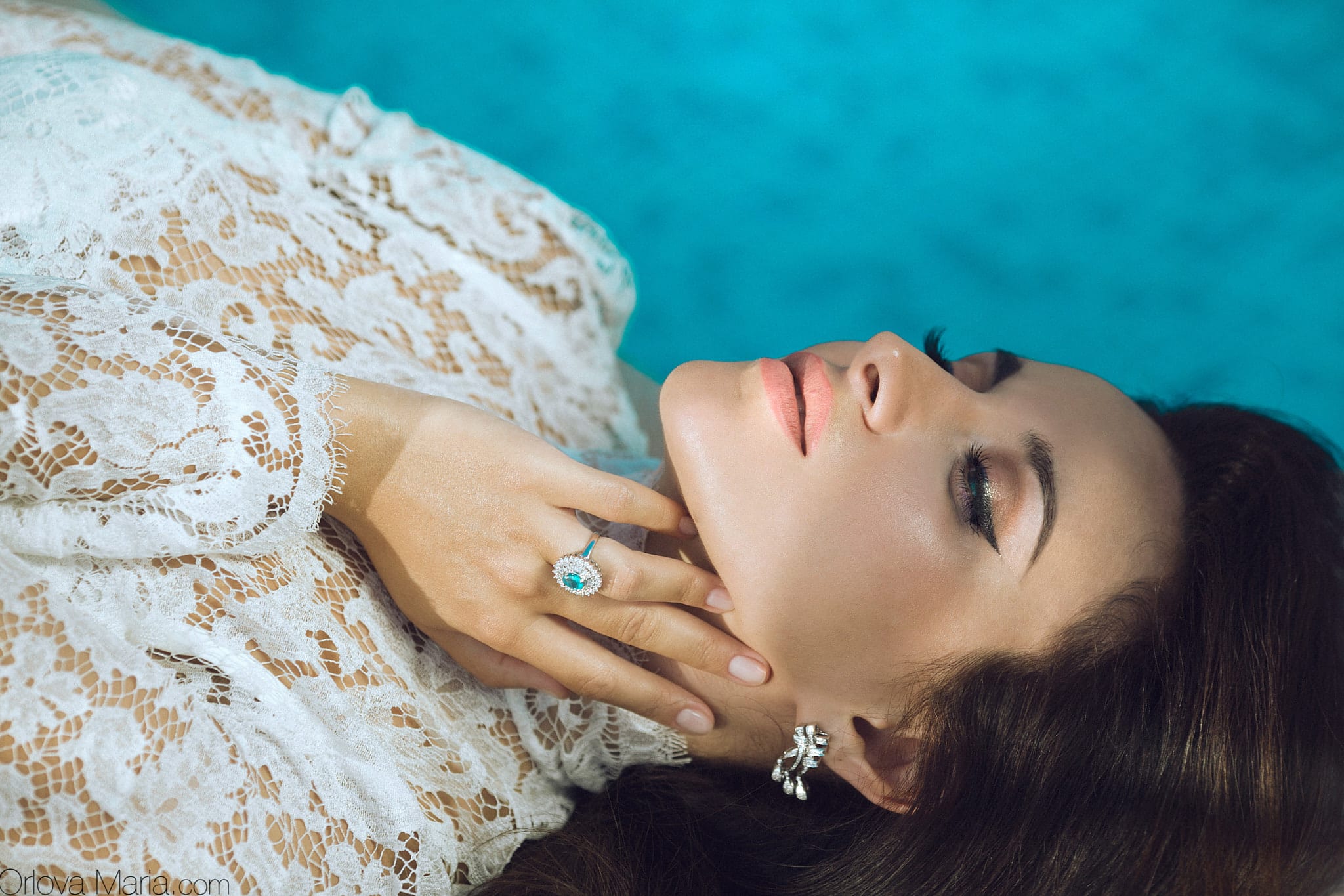 Model in lace by the pool.